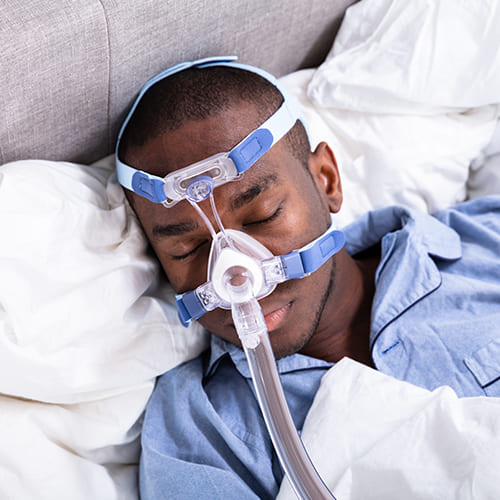 man sleeping with cpap mask